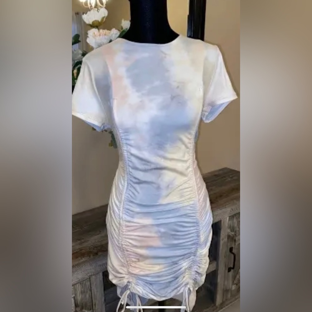Tie dye dress with light blush pink, blues and whites. Ruching at the bottom.